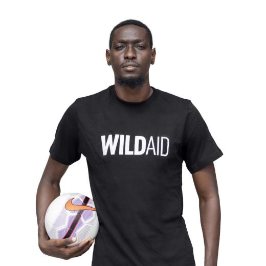 John Bocco wearing a WildAid t-shirt.